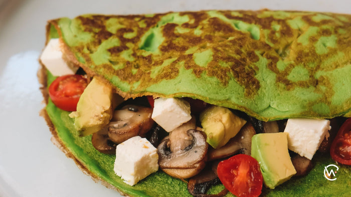 Spinach Egg Wrap with mushrooms, avo, tomato and feta inside