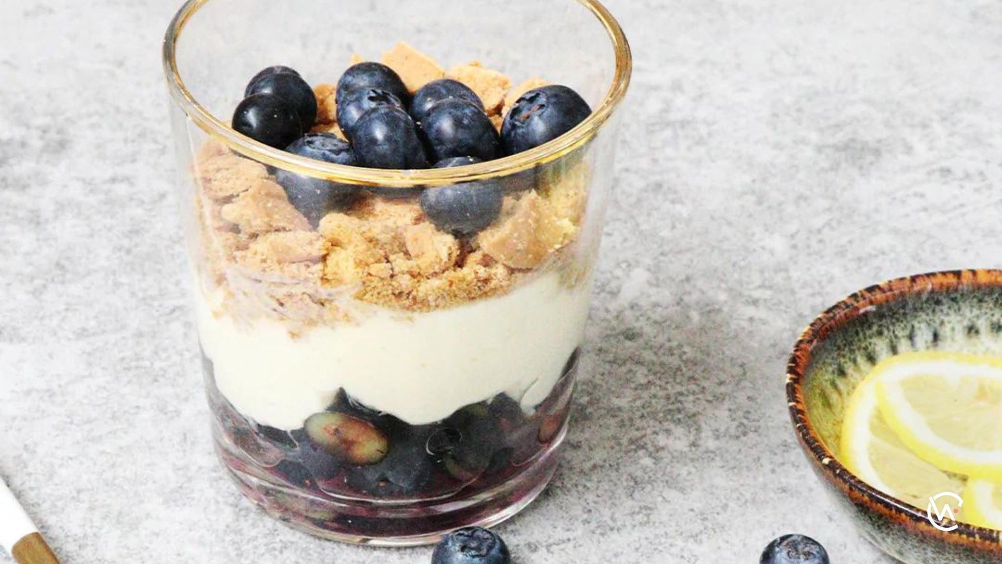 A glass of Blueberry lemon cheesecake