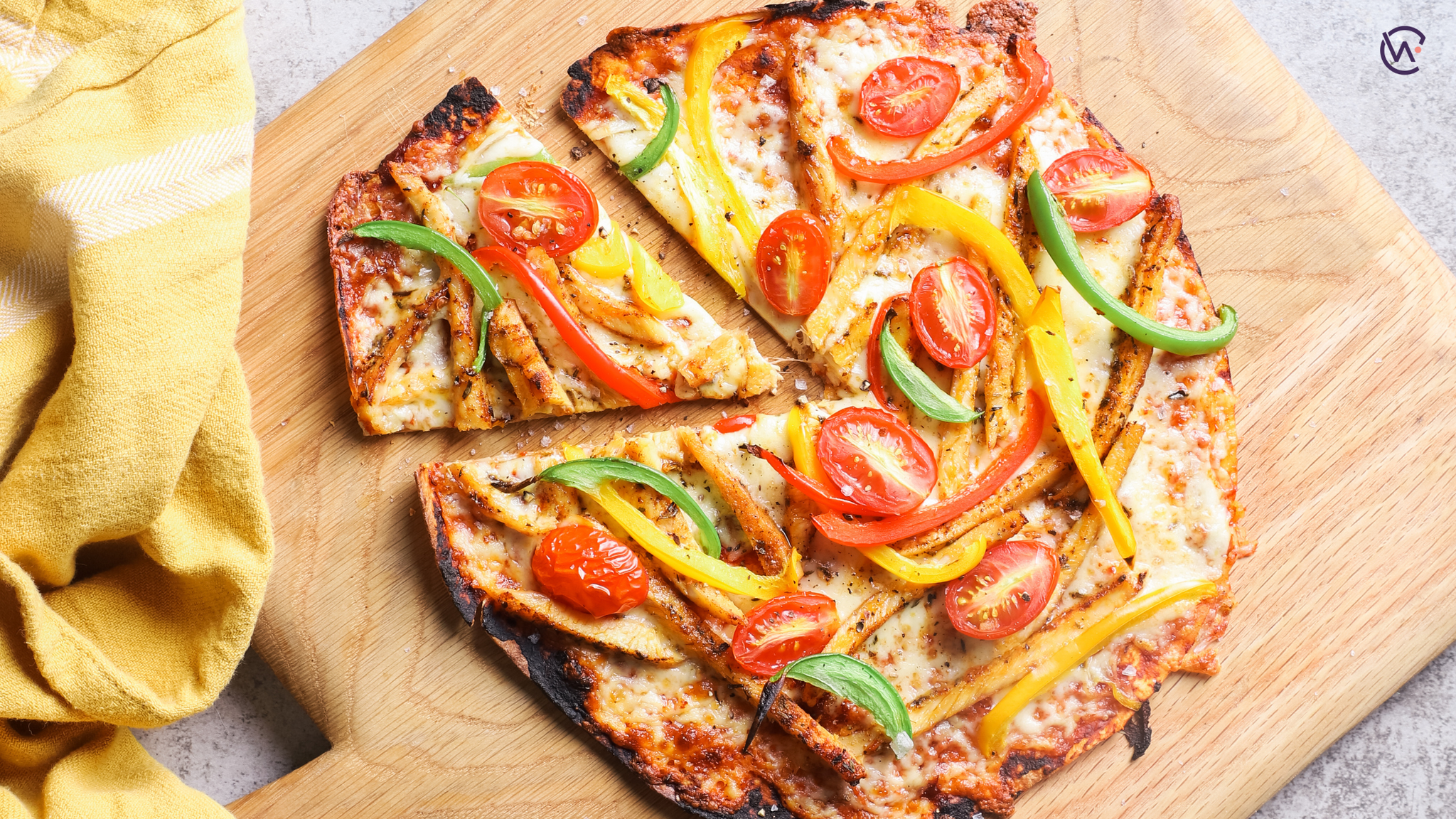 Smoked Paprika Chicken, Peppers and Baby Tomato Pizza with wrap base on a board