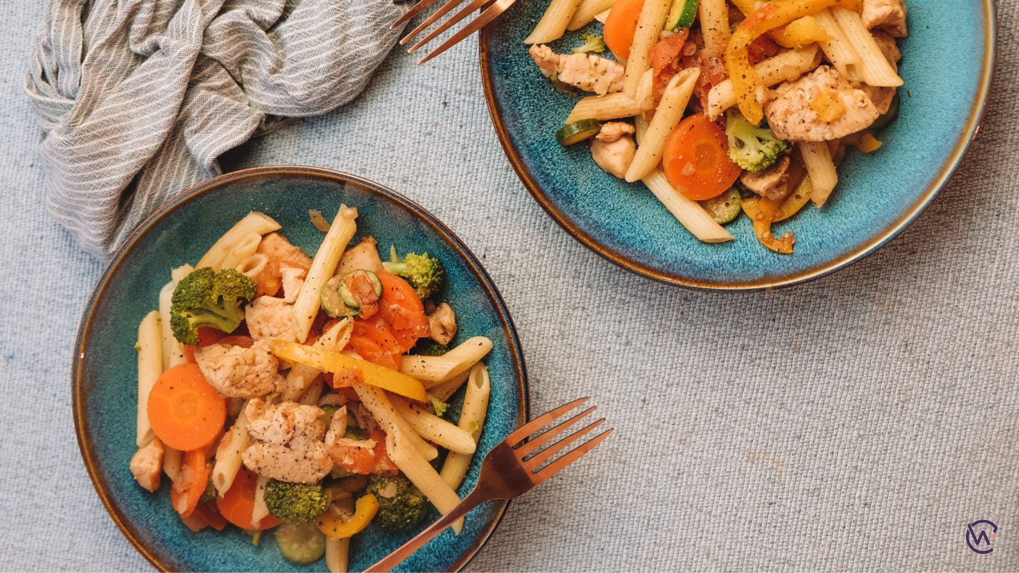 Two bowls of Chicken Stir Fry with penne pasta