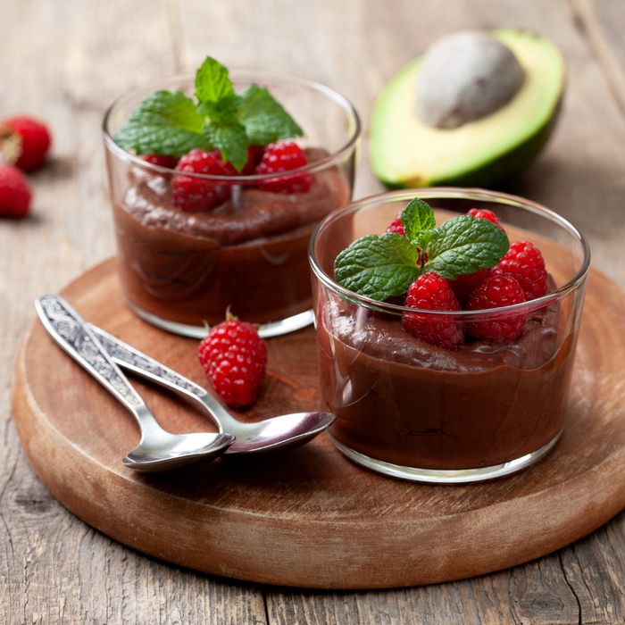 Two glasses of chocolate Avocado Mousse with berries on top