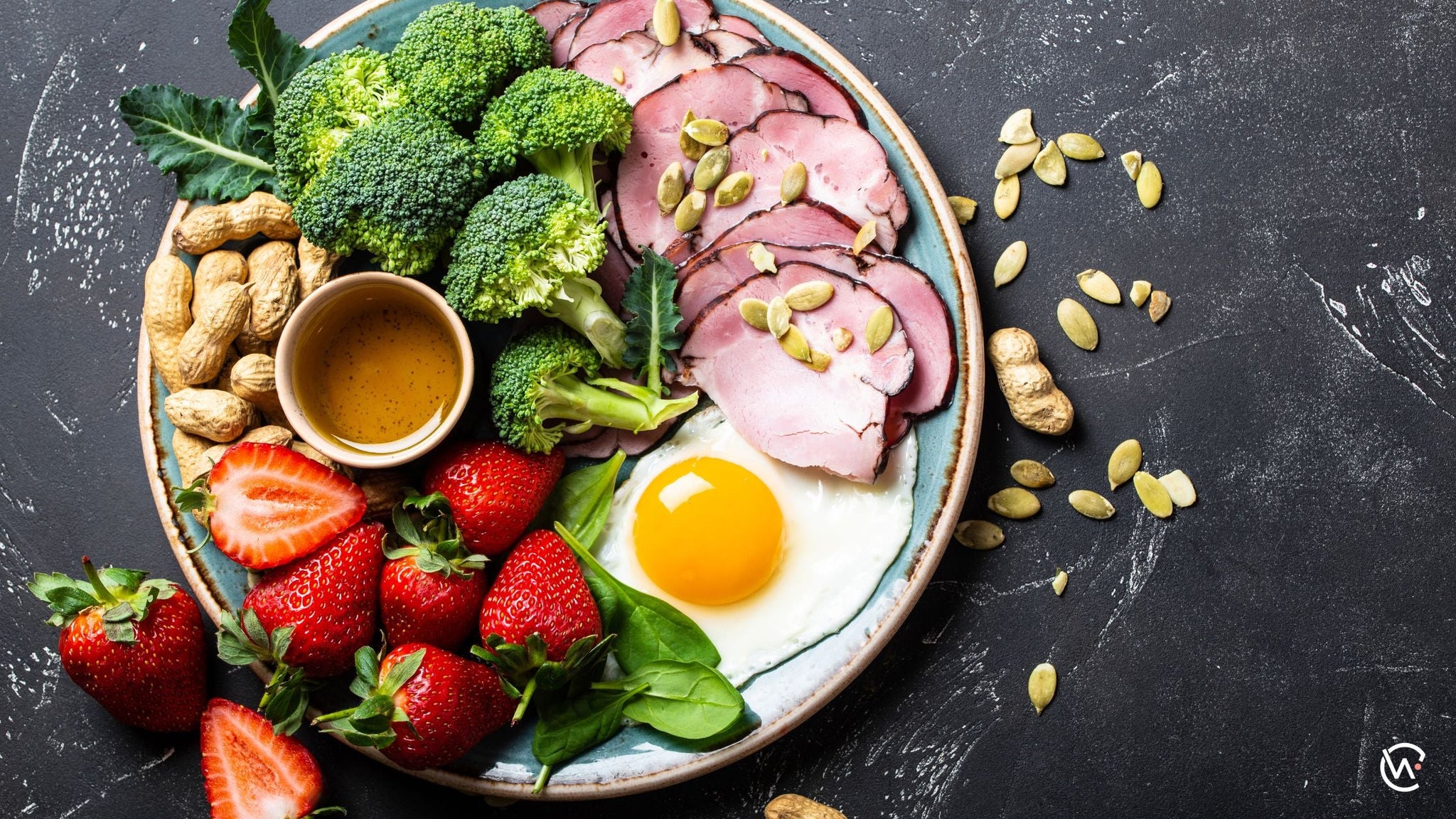 A plate of low carb foods including egg, vegetables, fruit and meat