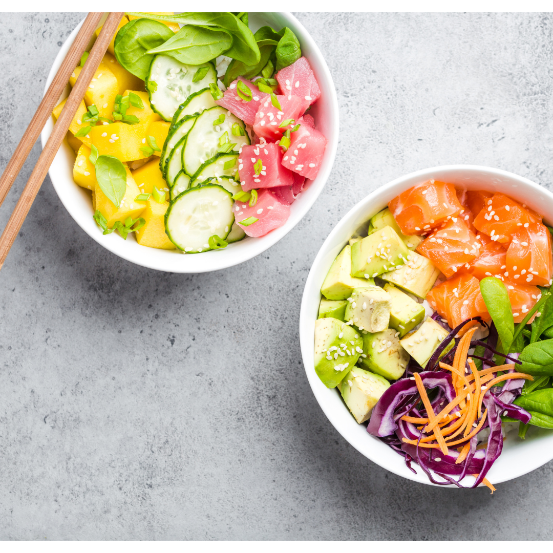 Two poké bowls with salmon, vegetables and tuna
