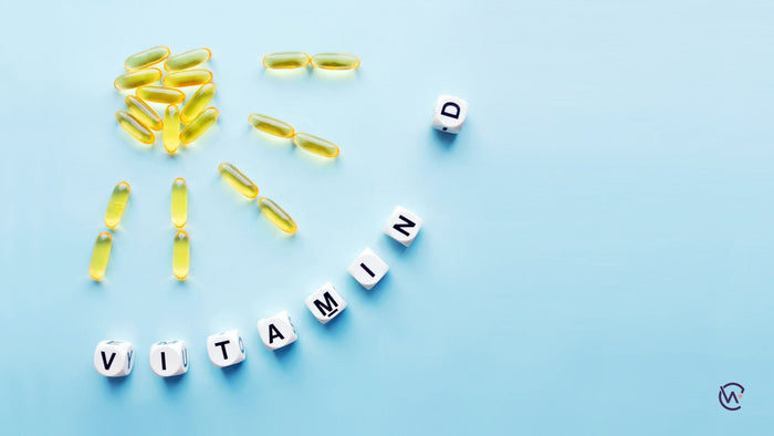 Vitamin tablets in the shape of the sun with the words "Vitamin D" spelled out in letter beads