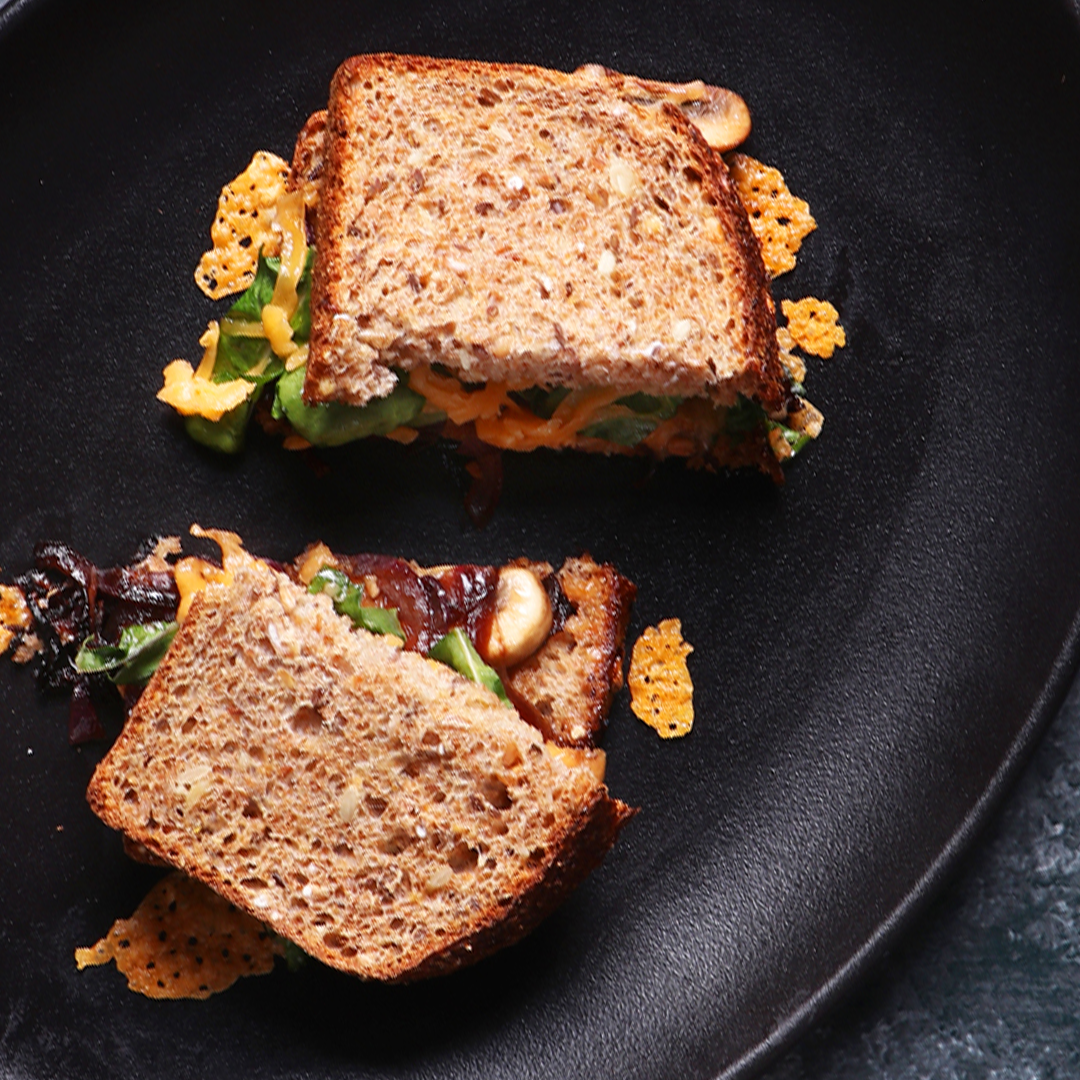 A caramelised onion toasted sandwich cut in half
